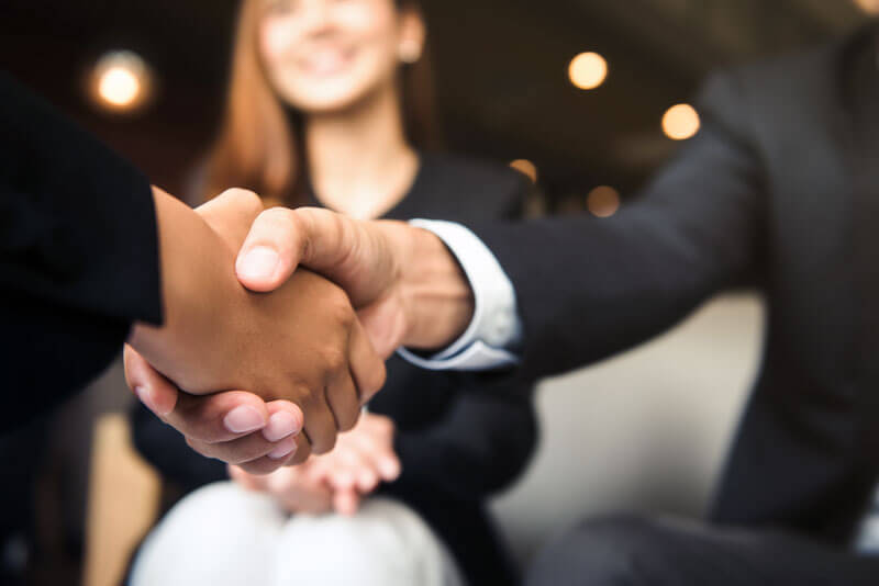 closeup of a handshake at a meeting